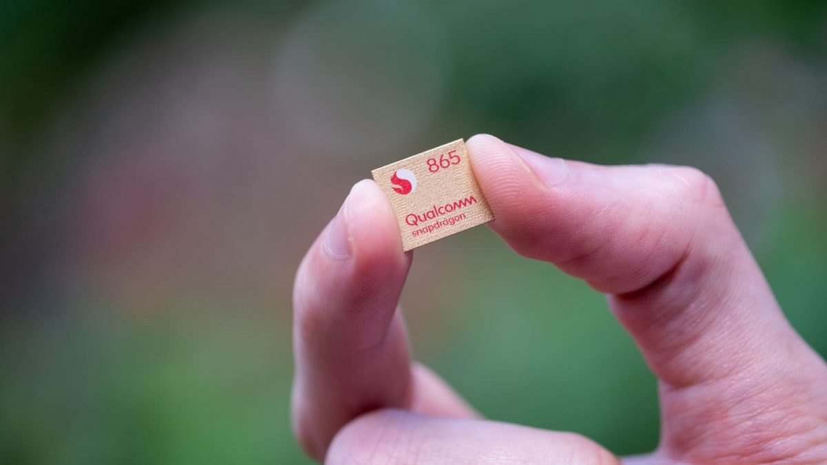 man holding Qualcomm chip